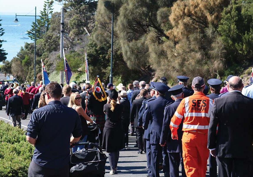 Hundreds of people marching down Sorrento's main street to the Cenotaph on the foreshore, for an ANZAC Day service.